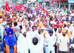 Brick-kiln workers stage a protest fearing closure of the kilns in Amritsar on Friday. 