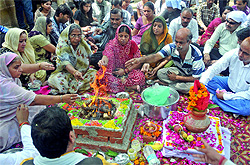 Family members of victims of the Delhi High Court blast perform havan at the court complex on the first anniversary of the attack on Friday