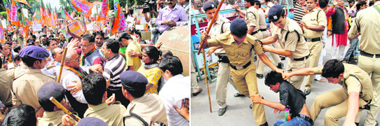 Policemen beat up a BJP worker for crossing the barricade during a protest outside the Secretariat in Dehradun on Friday; and (below) senior BJP leaders hold a demonstration. 