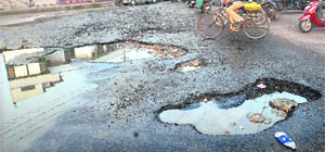 The road around BSF Chowk develops many potholes in Jalandhar. 
