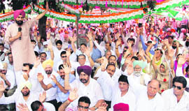 Congress leaders hold a protest against the imposition of property tax in Jalandhar on Friday. 