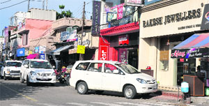 Vehicles of the Income Tax Department parked outside a jewellers shop in Jammu on Friday. 