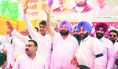 Capt Amarinder Singh accompanied by local Member of Parliament Manish Tewari and other Congress leaders during a dharna in Ludhiana on Friday.