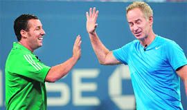 Adam Sandler and John McEnroe play an exhibition match against Jim Courier and Kevin James on Thursday. 