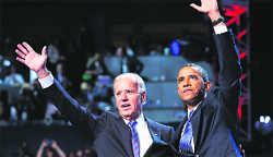 US President Barack Obama (R) waves with Vice-President Joe Biden after Obama accepted the presidential nomination during the final session of the Democratic National Convention in Charlotte.
