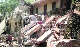 A collapsed house is seen after two quakes rocked Zhaotong on Friday.