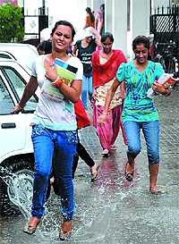 College students run for shelter from the rain that occurred in the city on Saturday afternoon. The light showers made the weather pleasant