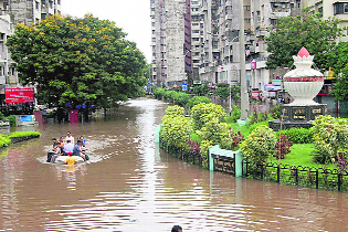 Patients being shifted to a safer place after heavy showers in Surat.