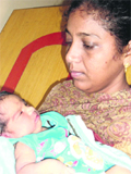 A woman holds the abandoned baby girl in her arms in Ludhiana. A Tribune photograph