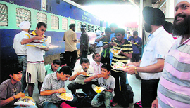 Sikhs hold a langar for the passengers of a Bengaluru-bound train at Guwahati railway station on Saturday.