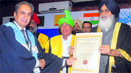 Chief Minister Parkash S Badal hands over a fellowship degree to a doctor from Pakistan in Jalandhar.