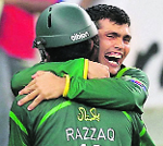 Kamran Akmal celebrates with Abdul Razzaq.  Reuters