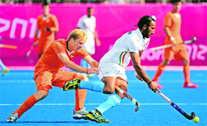 Netherland's Klaas Vermeulen (L) vies for the ball with Sardar Singh (R) in a match during the London 2012 Olympic Games.
