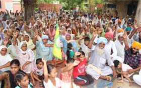 Residents of Lehra Mohabbat and members of various farmer unions stage a dharna in protest against the transfer of Dr Ashwani from a government medical facility at Lehra Mohabbat in Bathinda district, on Sunday