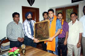 Director-principal of Dashmesh Public School Gurcharan Singh honours cricketer Prashant Chopra at Faridkot on Saturday