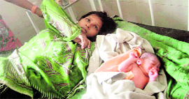 Woman with her newborn at the Civil Hospital, Bahadurgarh.
