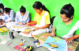 Students of OPS Vidya Mandir make posters during a competition organised by the JCI Club in Karnal.