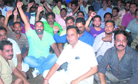 Congress workers stage a dharna in front of Basti Bawa Khel police station on Saturday.
