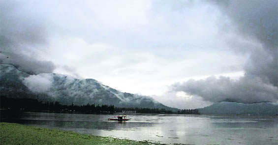 Mercury plummeted in the Valley as rain lashed the region. In this photo, rain clouds hover over the Dal Lake in Srinagar on Sunday.
