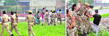 Police personnel disperse agitating unemployed teachers in Ludhiana on Sunday; and (right) they overpower a protester. 