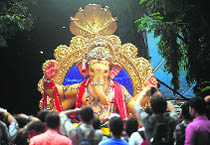 Devotees watch an idol of Lord Ganesha in Mumbai on Sunday. 
