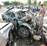An Iraqi soldier inspects the site of a blast in Kirkuk.
