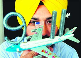 Artist Harwinder Singh Gill displays a model commemorating the attack on the World Trade Center in the USA, which occurred on September 11, 2001, in Amritsar on Monday