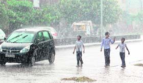 Children enjoy in the sudden rain that lashed Amritsar on Monday
