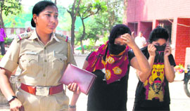 The girl along with her friend being taken to the Sector 26 police station in Chandigarh on Monday. 