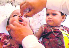 Polio drops are administered to a child as another child looks on at Phase I in Mohali.