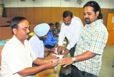 A person gets his finger marked after casting his vote during the Panjab University Senate elections at a polling booth in Chandigarh College of Architecture, Sector 12, Chandigarh, on Monday. 