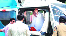 Chief Minister Vijay Bahuguna waves to the crowd at the Gurukul Kangri University Dayanand stadium in Haridwar on Monday.