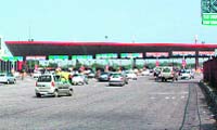 Vehicles move smoothly at the Delhi-Gurgaon toll plaza after the High Court orders to remove the toll barriers.