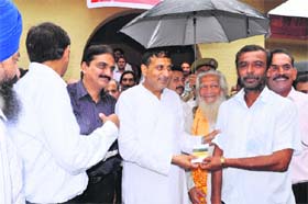 Minister of Health, Floriculture and Horticulture Sham Lal Sharma distributes Kisan Credit Cards to farmers in Akhnoor