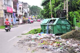 Garbage lying in the middle of the road in a posh locality of Gandhi Nagar