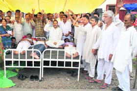 Relief holders hold a protest at the Jagti township of Nagrota in Jammu
