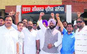Congress workers stage a protest outside the office of Police Commissioner in Jalandhar on Monday.