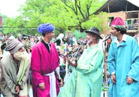 Locals watch a folk theatre performance at Seer Handan in Anantnag