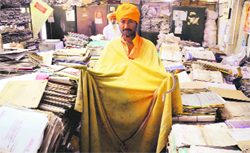 A snake charmer catches a snake from the Excise Department office in Ludhiana on Monday. Tribune photo: Himanshu Mahajan