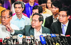 Albert Ho (centre) of the Hong Kong Democratic Party address the media after resigning on Monday.  AFP