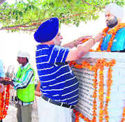 Residents pay floral tributes to Shaheed Sardar Nanak Singh at his statue on his birth anniversary in Amritsar on Tuesday.