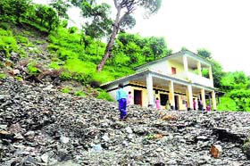 A landslide poses danger to a government primary school near Dalhousie
