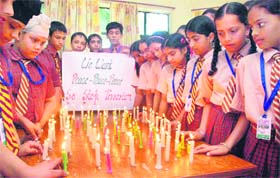 FOR PEACE: Students of St Soldier School, Mithu Basti, light candles to pay tributes to victims of 9/11 attack on World Trade Center, in Jalandhar on Tuesday