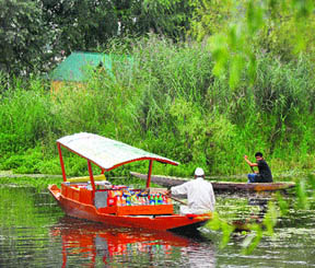 A shopkeeper ferries goods on a boat on the Dal Lake in Srinagar. 