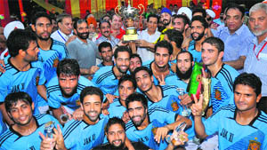 Jammu Football Club with trophy after winning a goodwill match played against Mohun Bagan at the Science College football ground on Tuesday.