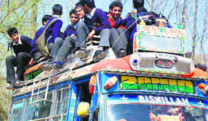 Students of a school travel atop a bus in south Kashmir. Most private schools do not offer transport facilities that conform to the SC directives. 