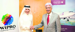 Qatar Airways CEO Akbar Al Baker shakes hands with Wipro chairman Azim Premji after signing a partnership agreement in Doha. Tribune Photograph