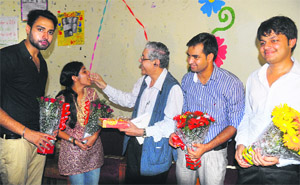 Vice-Chancellor Prof Arun Grover offers sweets to the newly elected office-bearers of the student council after the oath-taking ceremony at Panjab University in Chandigarh on Wednesday. 