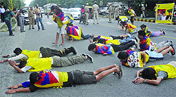 The exiled Tibetans take out a peaceful prostration march leading to the UN Information Centre in New Delhi on Wednesday. They urge China, using the good offices of the international body, to allow representatives of governments and the media to visit Tibet