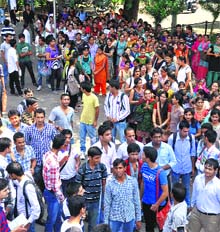 Students protest in favour of their demands on the main gate of University of Jammu on Wednesday.